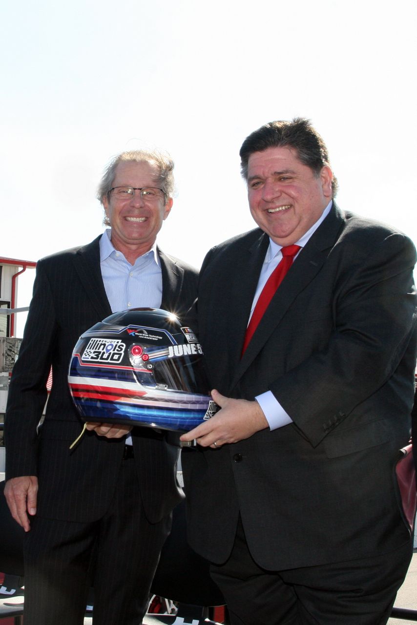 Gov. JB Pritzker receives helmet from Curtis Francois during announcement about Enjoy Illinois 300 race